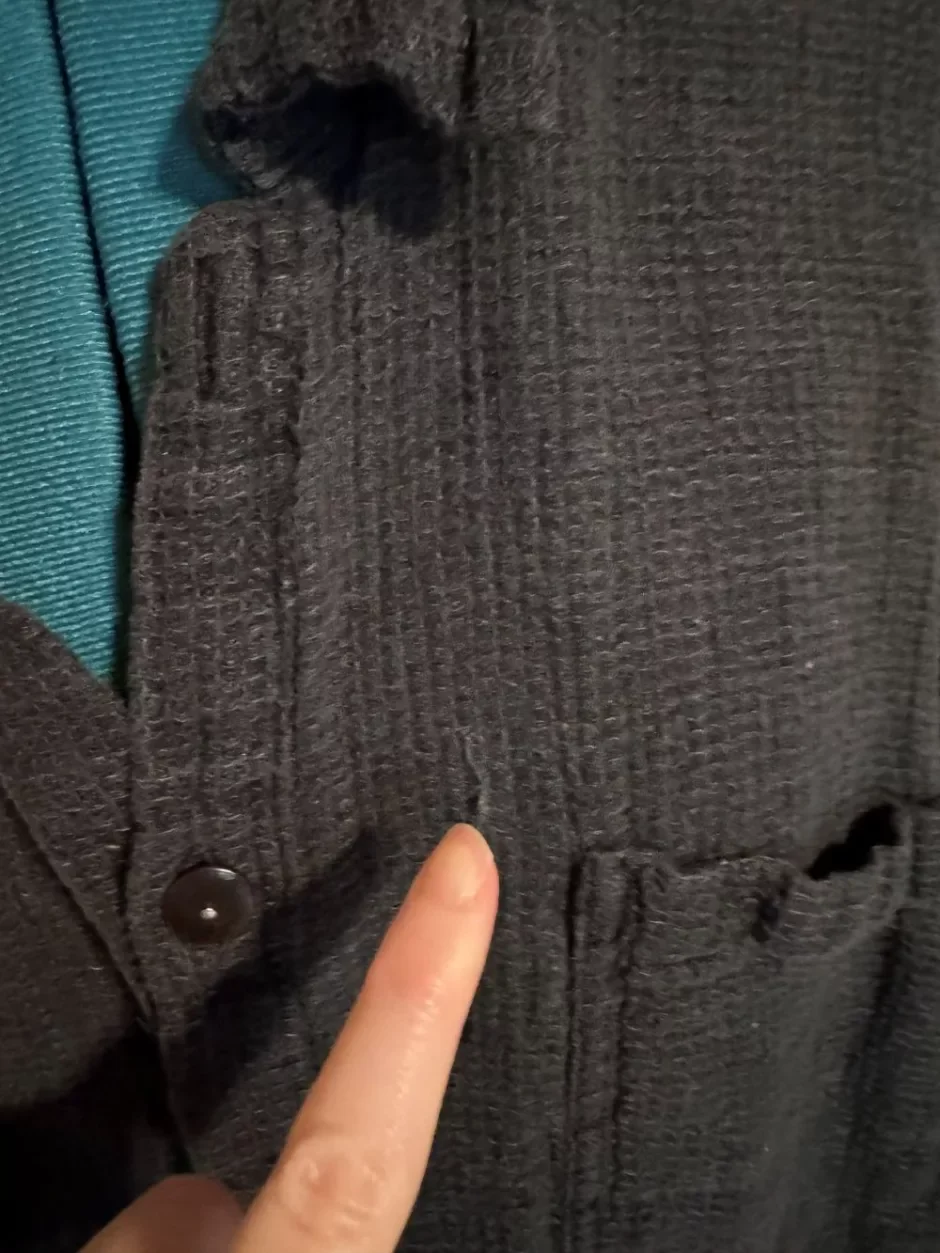 Close-up of small snags and pulls in a linen shirt