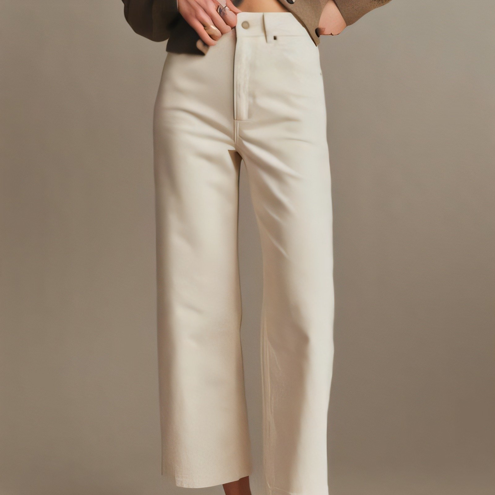 Cream high-rise jeans paired with a warm knit sweater